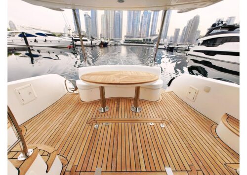Teak aft deck with dining table on a 50 ft yacht in Dubai Marina