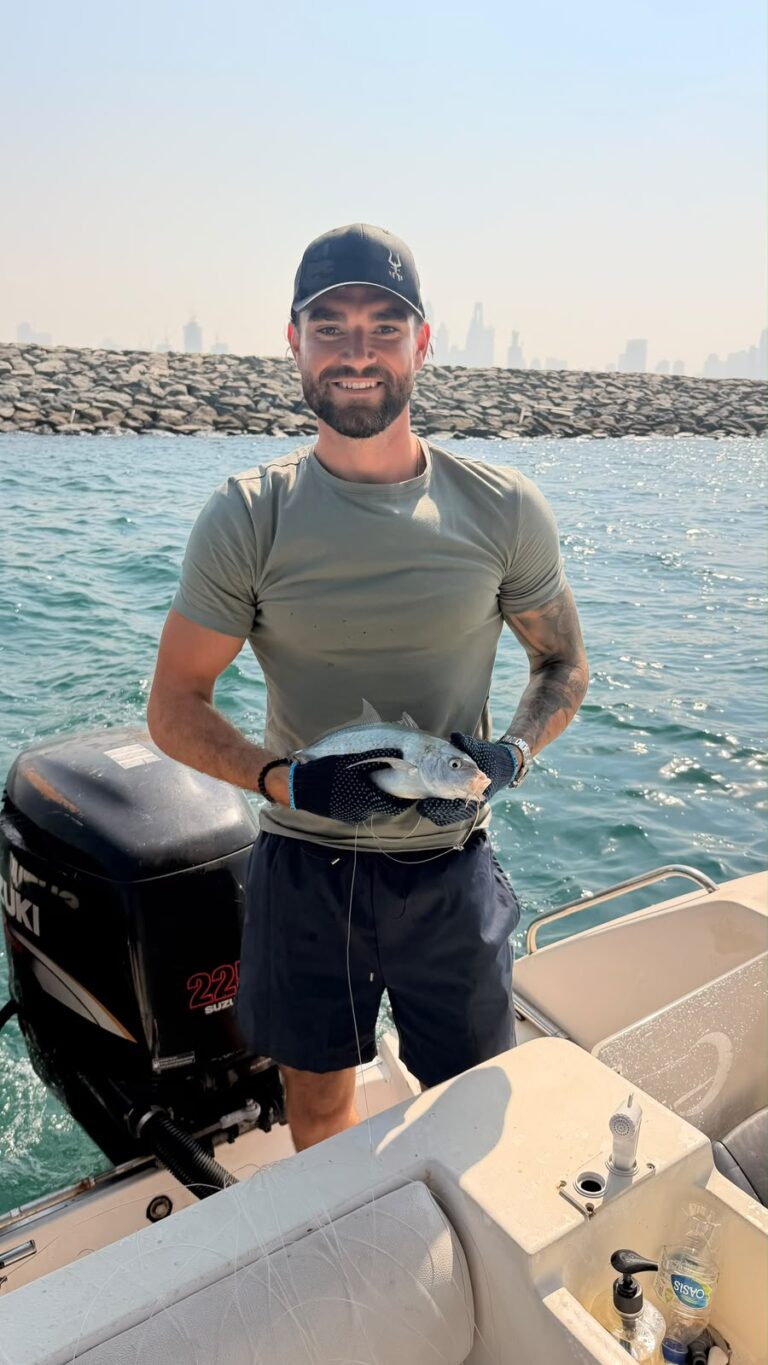 Angler holding a fresh catch on a deep sea fishing trip in Dubai